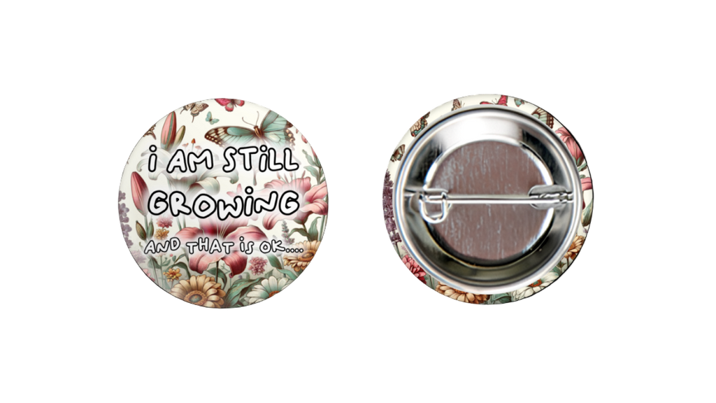 Button badge with 'I am still growing' text on a floral background